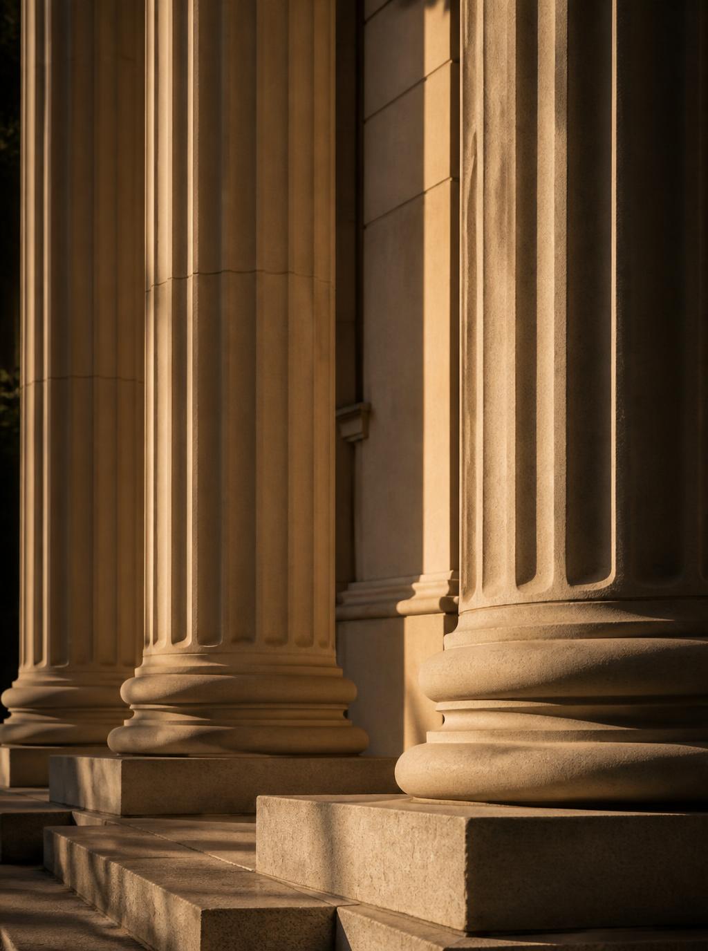 Stone colonnade of a courthouse in golden light
